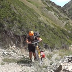 A bicyclist pedaling up a hill