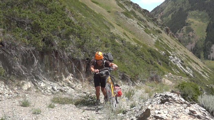 A bicyclist pedaling up a hill